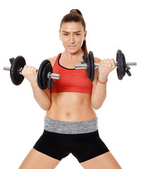 Obraz premium Fitness girl working with weights