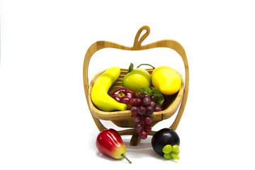 Assortment of exotic fruits in basket, isolated on white