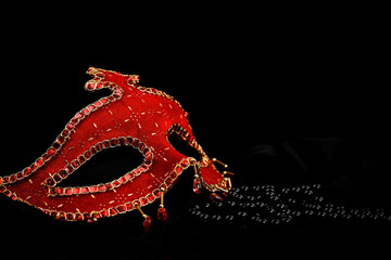 Fototapeta premium Red mask and black pearls