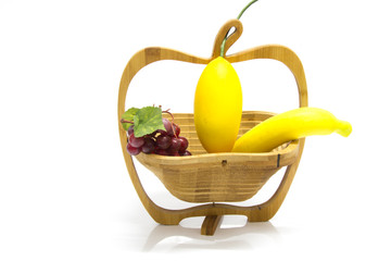 Assortment of exotic fruits in basket, isolated on white