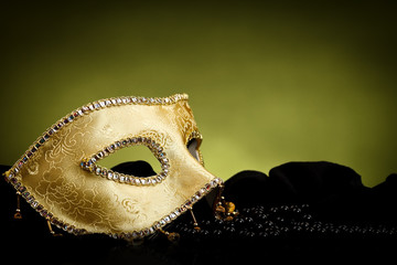 Golden mask over light background