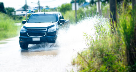 Car driving thru the flood water