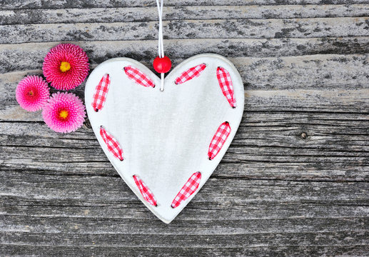 Heart with flowers on a wooden background old