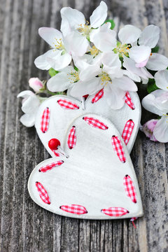 Spring Blossom and hearts over wooden background