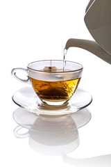 Tea being poured into glass tea cup