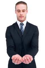 Concentrated businessman holding out his hands