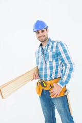 Happy construction worker holding wooden planks