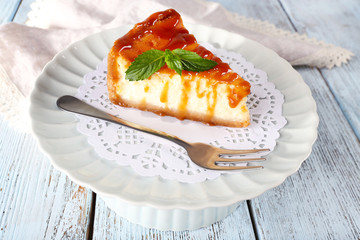 Cheese cake on paper napkin on plate on wooden background