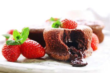 Hot chocolate pudding with fondant centre with strawberries,