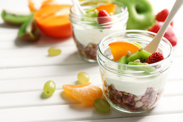 Healthy dessert with muesli and fruits on table