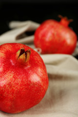 Fototapeta na wymiar Juicy ripe pomegranates on tablecloth