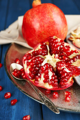 Juicy ripe pomegranates on wooden table