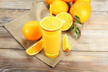 Glass of orange juice with straw and slices