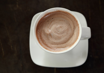Hot chocolate in a white cup on table