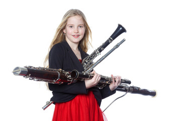 young girl holds woodwind instruments in studio