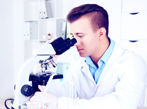Young male researcher carrying out scientific research in lab