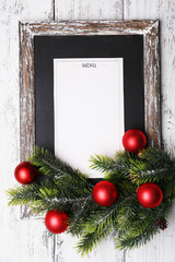 Menu board with Christmas decoration on wooden planks
