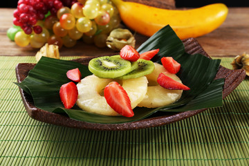Fruit dessert on green leaf on table