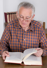 Old man reading a book