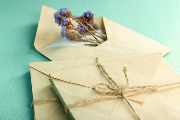 Old letters with dry flowers on wooden background