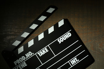 Movie clapper on wooden background