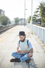 young handsome hipster gay modern man using smartphone