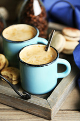 Beautiful composition with tasty cappuccino on wooden table