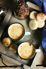 Beautiful composition with tasty cappuccino on wooden table