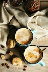 Beautiful composition with tasty cappuccino on wooden table