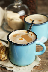 Beautiful composition with tasty cappuccino on wooden table