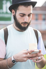 young handsome hipster gay modern man using smartphone