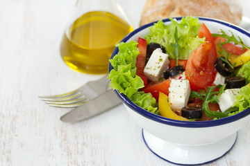 salad in white bowl and oil