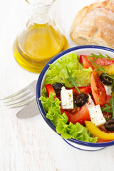 salad in white bowl and olive oil