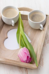 Obraz na płótnie Canvas two cups of coffee with tulip