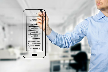 designer drawing mobile website development wireframe