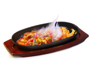 Sizzling and burning fajitas on a frying pan