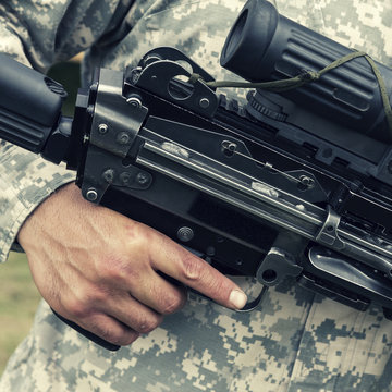 Soldier holding automatic gun
