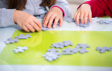 Two children playing with puzzles