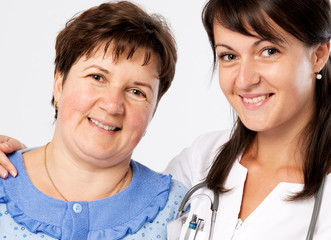 Senior woman with nurse at hospital smiling