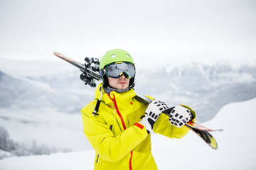 Fototapeta na wymiar Skier carrying skis
