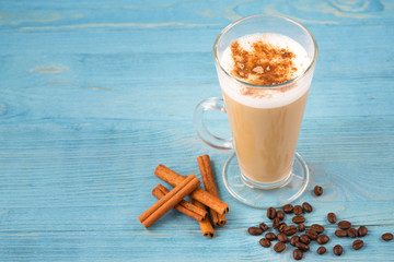 Cafe latte and coffee beans and cinnamon