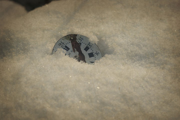 broken old watch on the snow