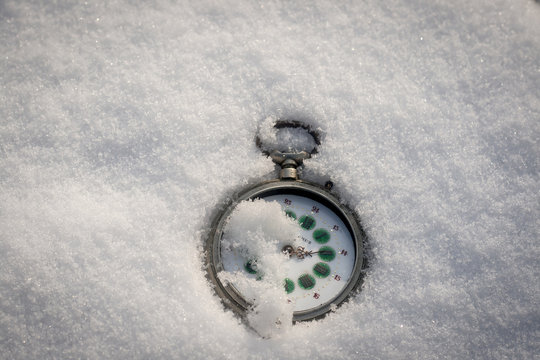 old pocket watch on the snow