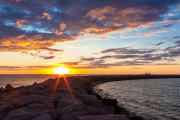 Obraz premium Sunset over breakwater