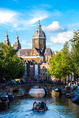 Canal and St. Nicolas Church in Amsterdam - obrazy, fototapety, plakaty