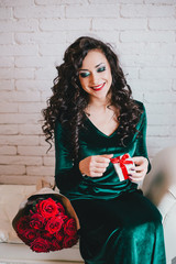 Happy beautiful woman opening present for Valentine's Day