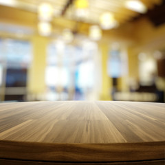 Empty wooden round table and blurred background for product pres
