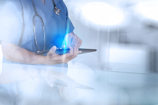 Doctor working with tablet computer on blue background