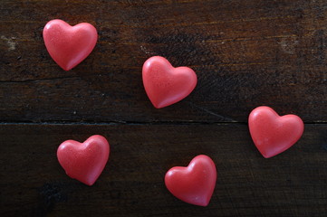 Red hearts on wooden background
