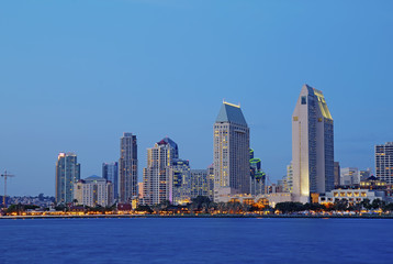 Partial skyline of San Diego over water at night